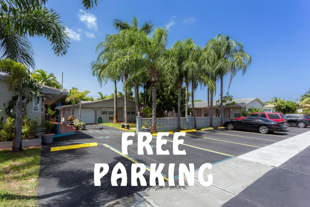 a parking lot with palm trees and the words free parking at Richard's Motel Extended Stay in Hallandale Beach