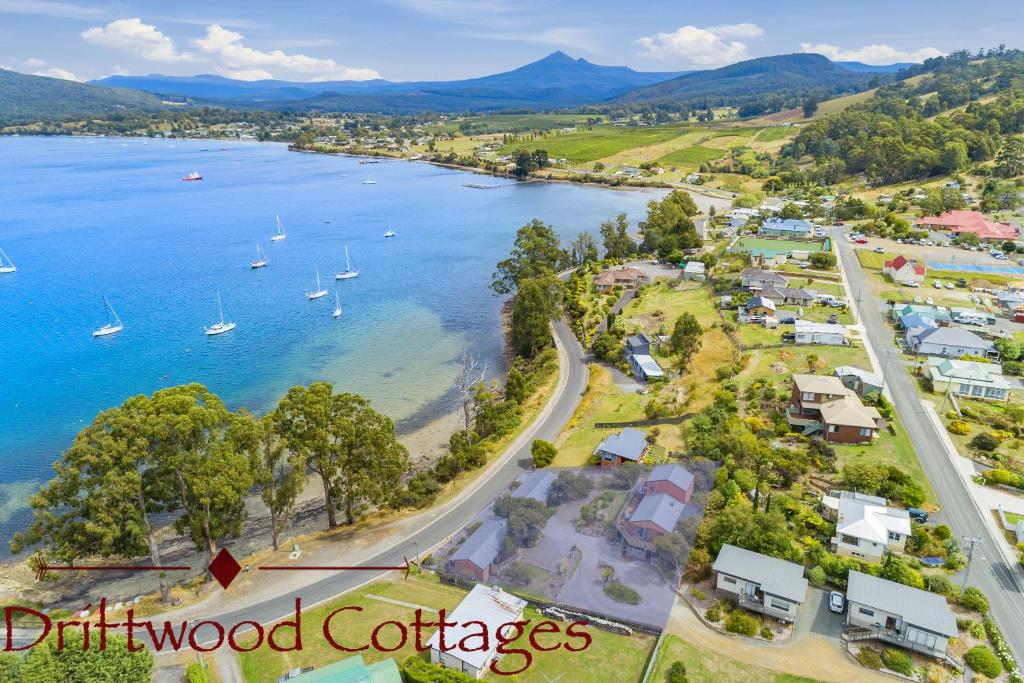 an aerial view of driftwood cottages on the shore of a lake at Driftwood Cottages, Waterfront Studios in Dover