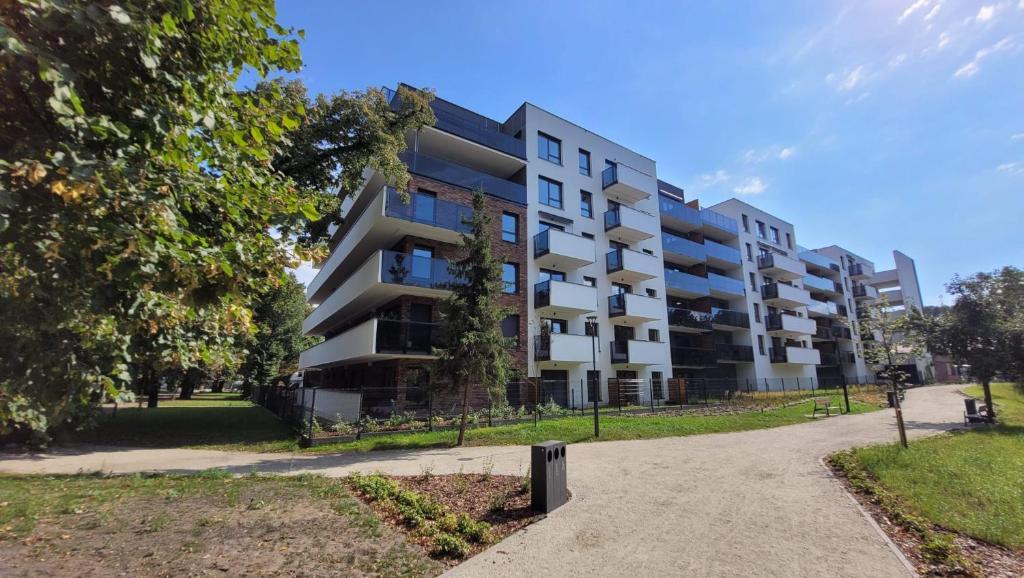 un edificio de apartamentos en un parque en Apartamenty Przy IV Śluzie - Gold, en Bydgoszcz