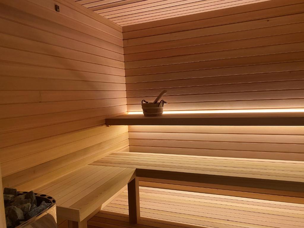 a sauna with a potted plant sitting on a shelf at Greif Hotel Maria Theresia in Trieste