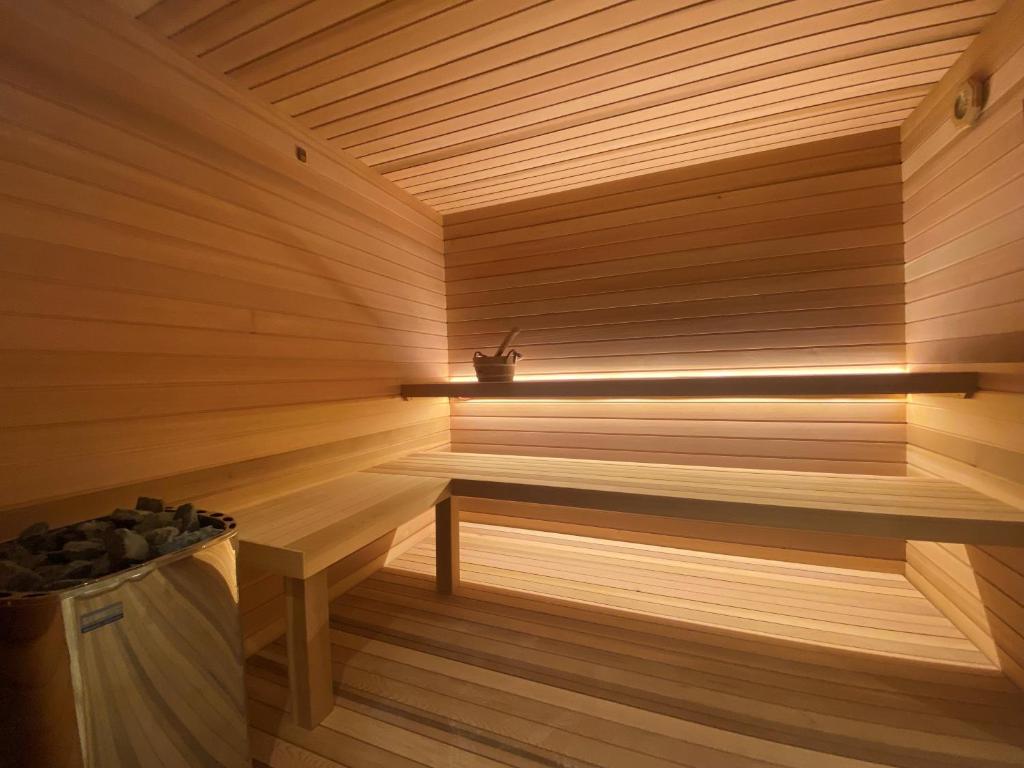 a sauna with a bench and a plant at Greif Hotel Maria Theresia in Trieste