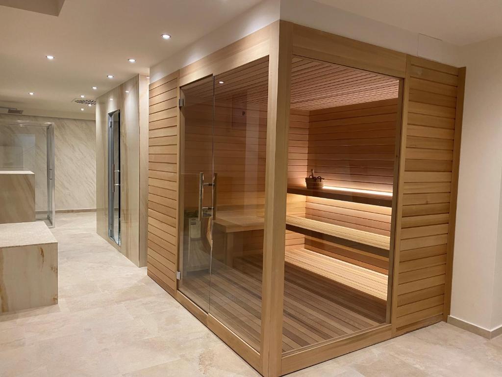 a sauna in a bathroom with wooden walls at Greif Hotel Maria Theresia in Trieste