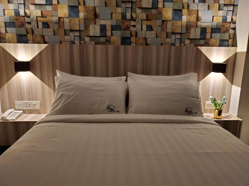 a bedroom with a large bed with a wooden headboard at Apex Boutique Hotel @ Bandar Sunway in Petaling Jaya