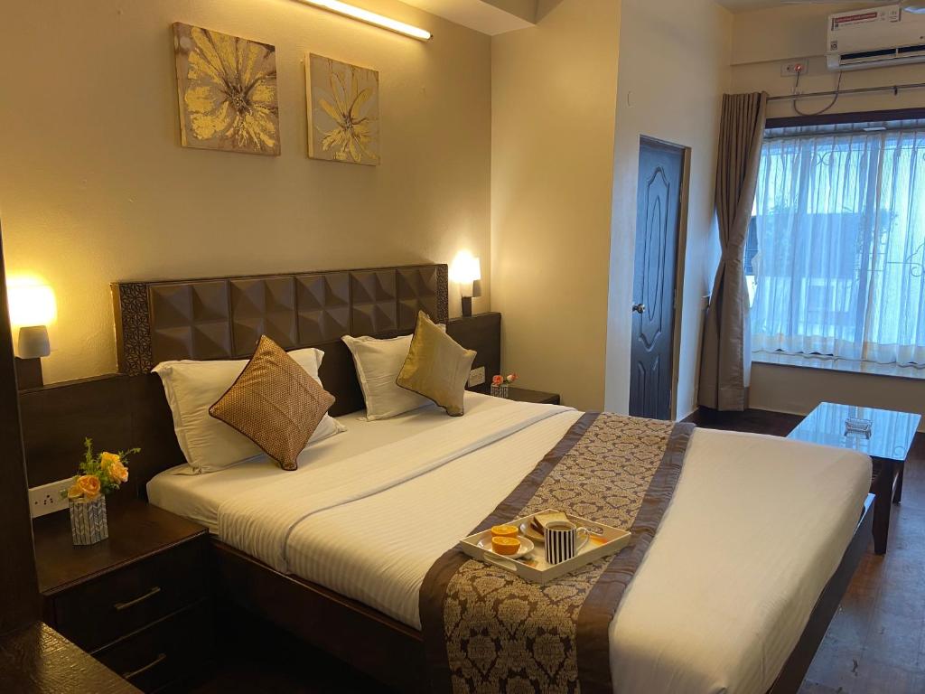 Postel nebo postele na pokoji v ubytování Aster Guest House