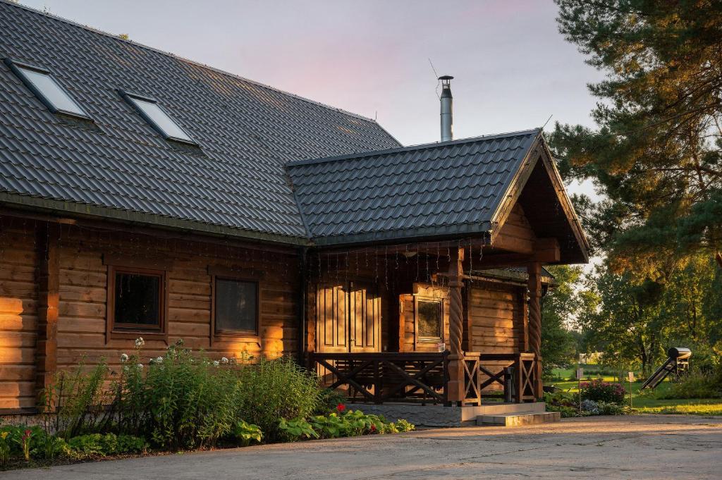 a wooden cabin with a gambrel roof at House of Sparkles in Elektrėnai