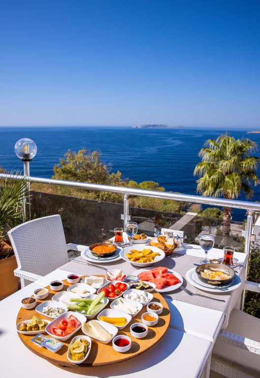 a table with plates of food on a balcony at La Kumsal Hotel in Kaş