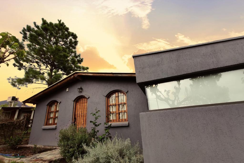 a house with windows on the side of it at Casa Huellas de Malbec - Montaña y paz in Las Compuertas