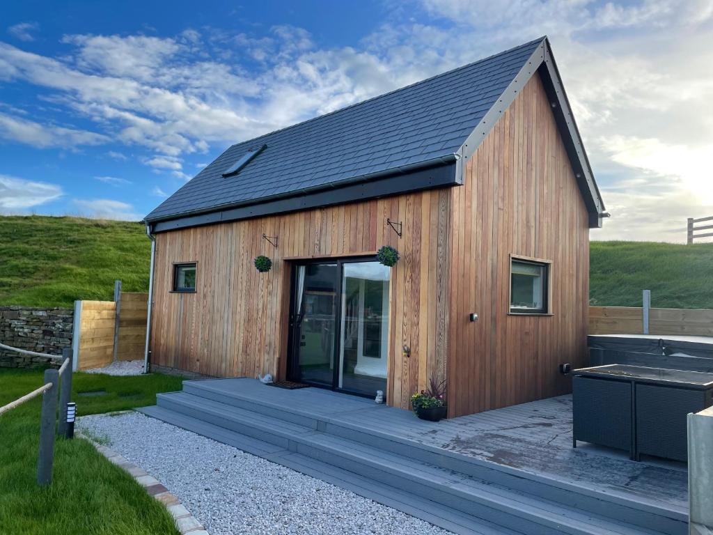 a wooden barn with a large glass door at Beechwood Nook- Crown Lodges in Crawshaw Booth