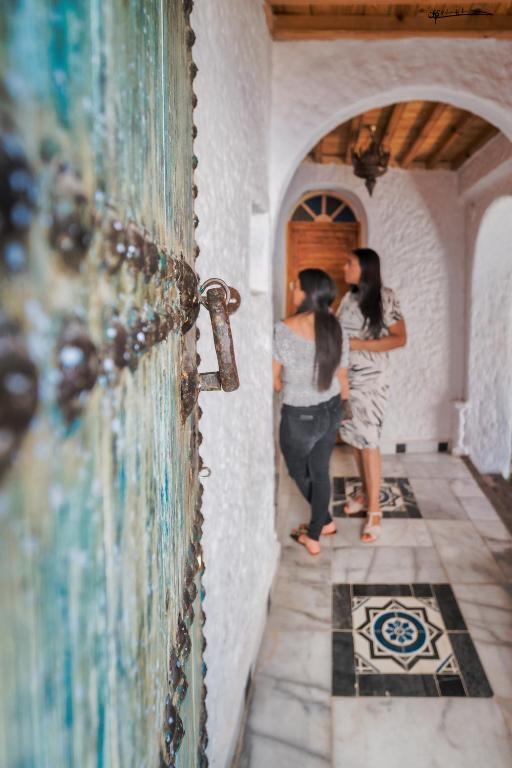 two women standing in the hallway of a house at RIAD LA SANTA in Chefchaouen