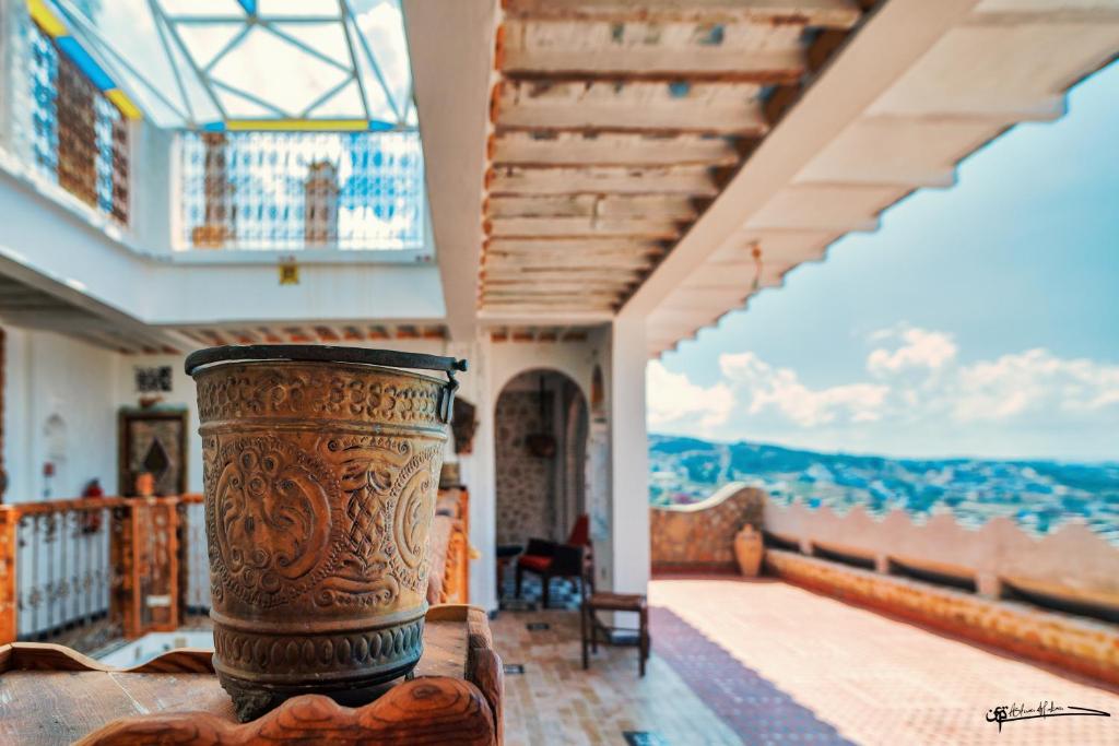 a vase on a table in a room with a view at RIAD LA SANTA in Chefchaouen