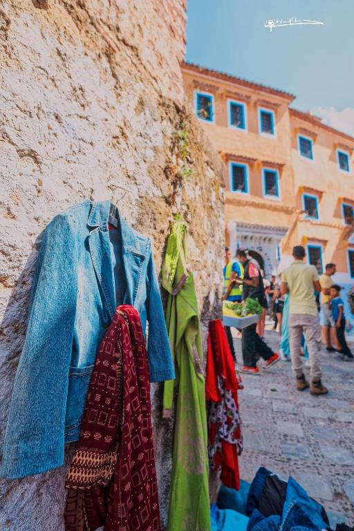 a group of people standing next to a wall at RIAD LA SANTA in Chefchaouen