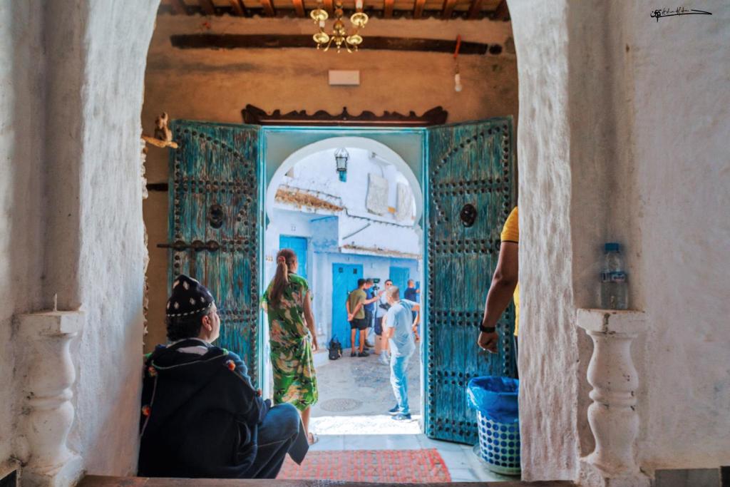 a group of people walking through a doorway in a building at RIAD LA SANTA in Chefchaouen