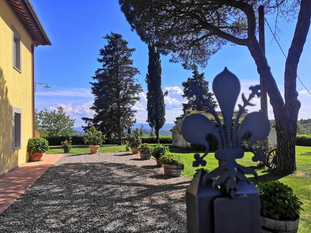 a pathway leading to a garden with trees and plants at Tenuta Barbadoro agriturismo apartment in Montespertoli