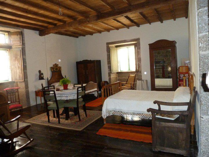 a bedroom with a bed and a table and chairs at Casa do Pacio Sabadelle in Lugo