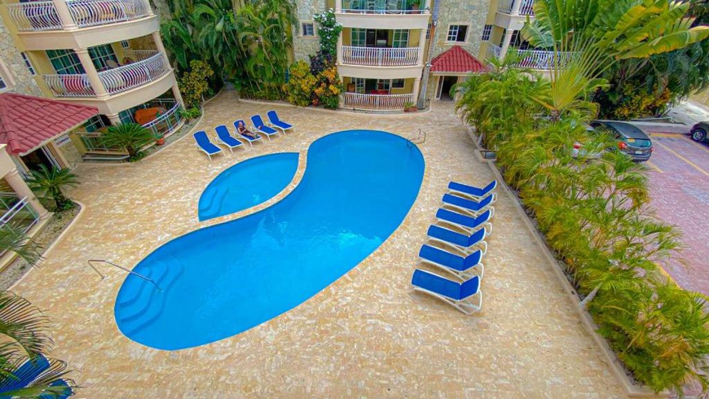 a swimming pool with a blue skateboard in a courtyard at The Corals Punta Cana (Mar de los Corales ll ) in Punta Cana