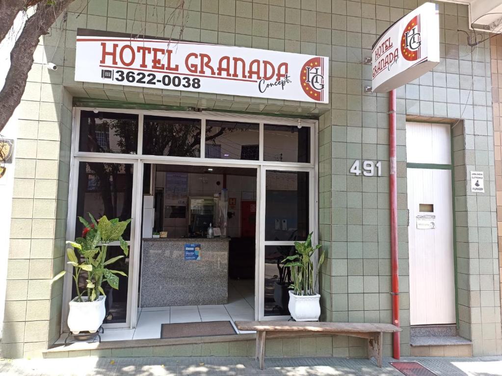 a hotel garage with potted plants in front of it at Hotel Granada Concept in Manaus