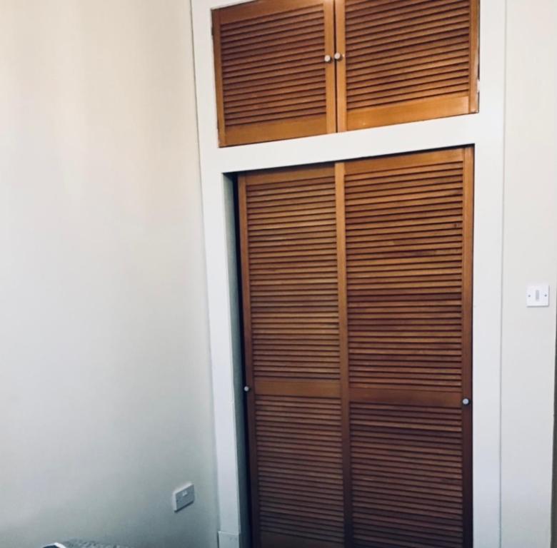 a pair of wooden doors on a building at Largs Holiday Apartment in Largs