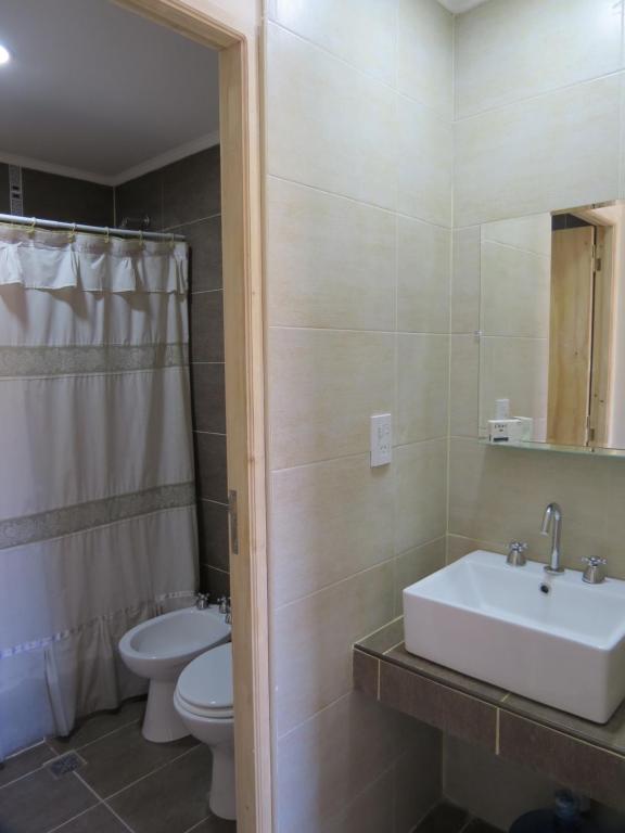 a bathroom with a sink and a toilet at Cabaña La Verdicchio Urbanización Cristobal Lote 2 in Valle Grande