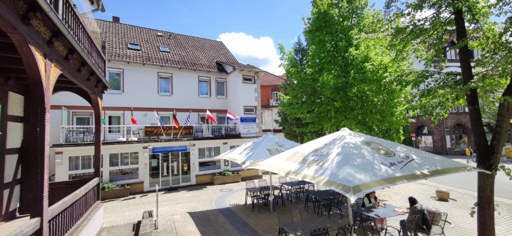 a group of tables and umbrellas in front of a building at Haus Steinmeyer in Bad Pyrmont