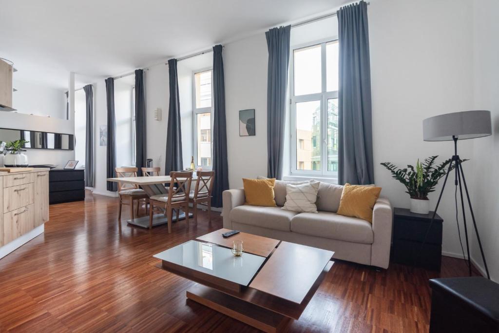 ein Wohnzimmer mit einem Sofa und einem Tisch in der Unterkunft Cozy and central City Apartment at the Belvedere in Wien