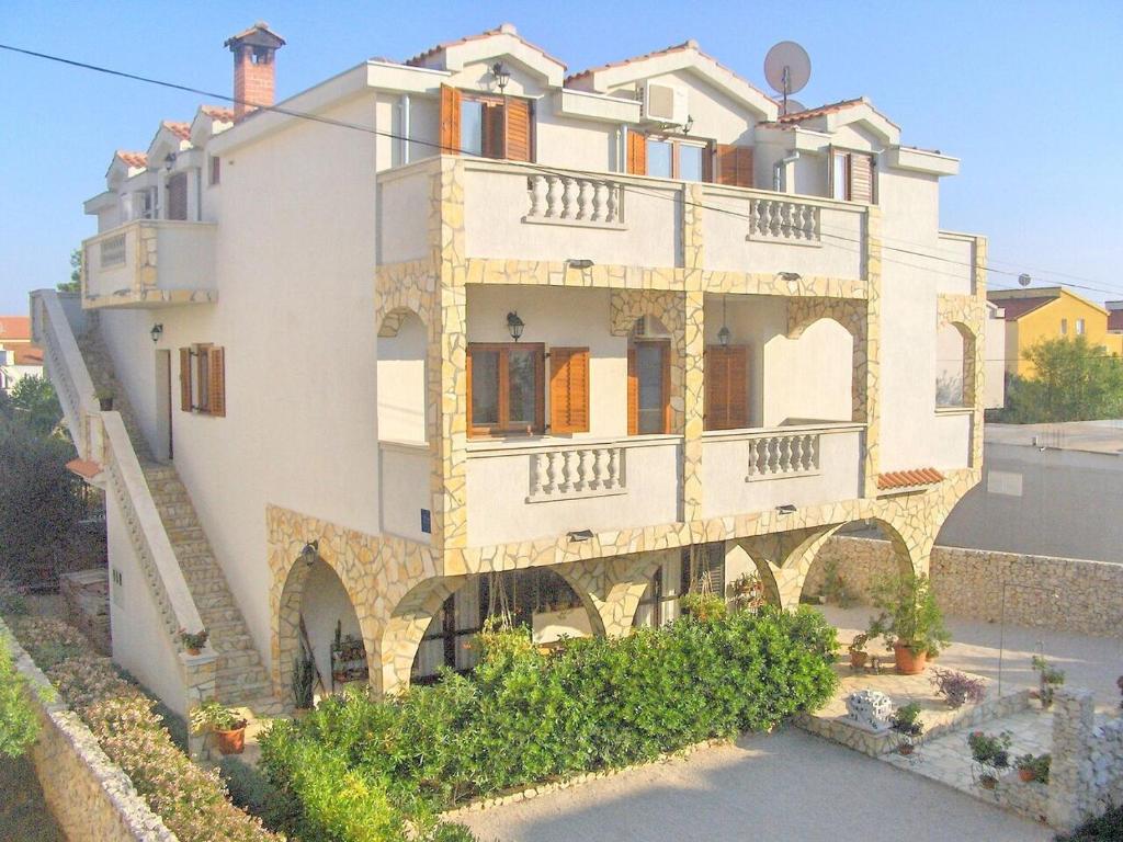 a large white building with balconies on it at Apartments Villa Estella in Srima