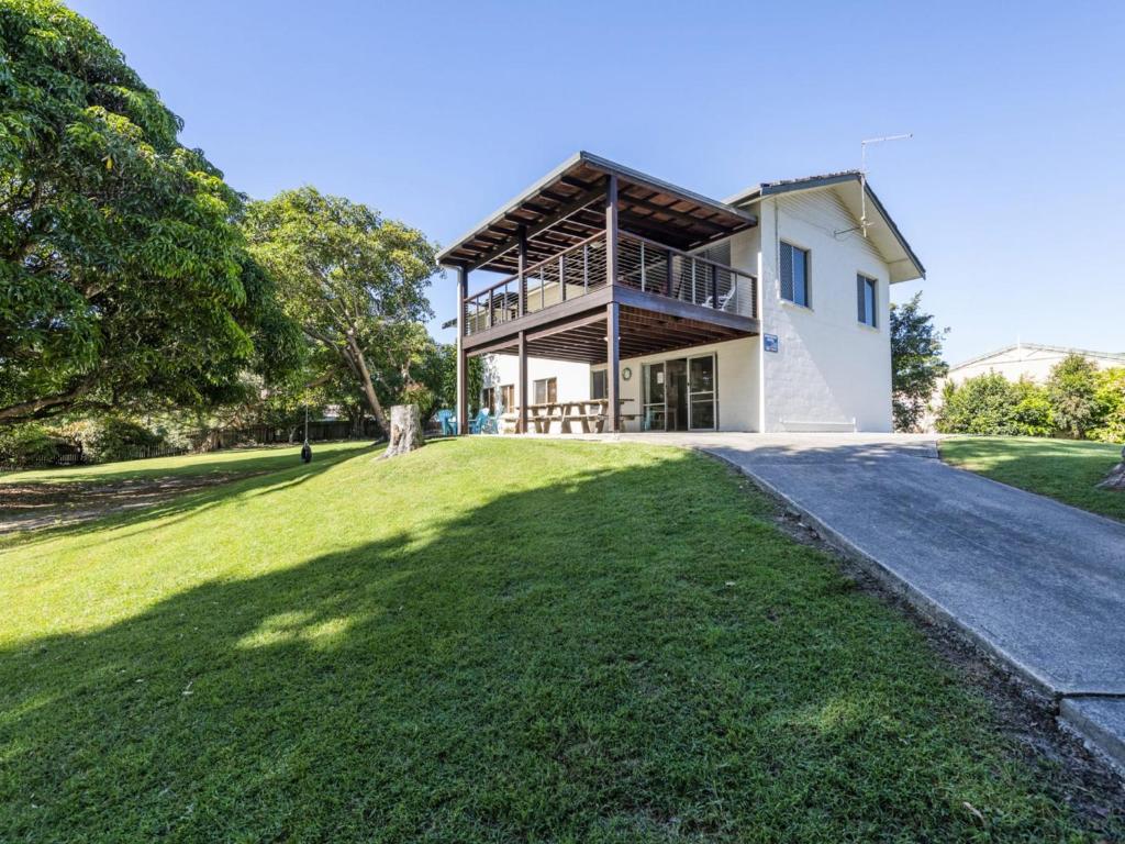 a house with a large lawn in front of it at Greenwood House in Iluka