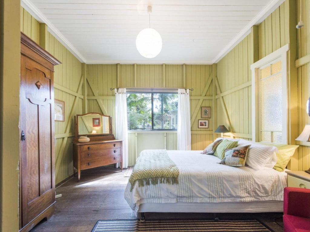 a bedroom with a bed and a window at little beach house in Iluka