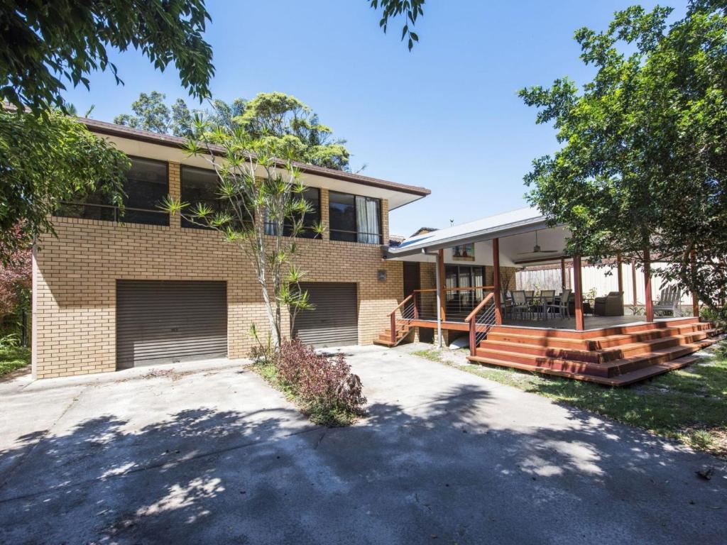 a brick house with a driveway in front of it at Ripples on the Bay in Iluka