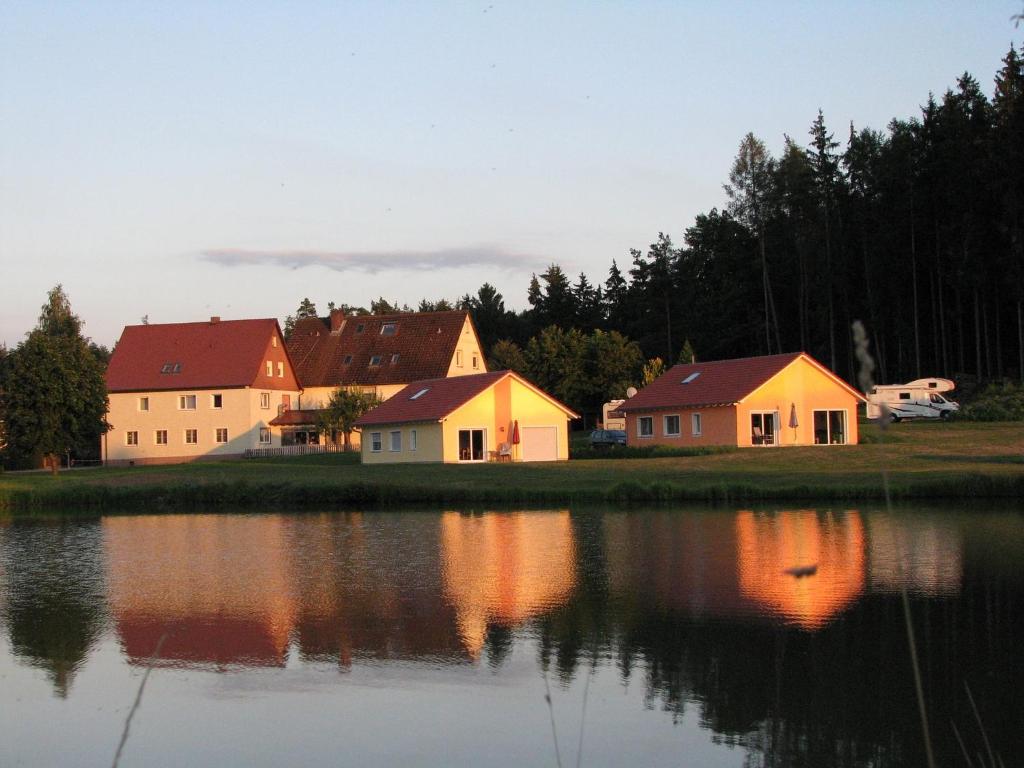 a group of houses next to a body of water at Karpfenhaus Feuchtwangen in Feuchtwangen