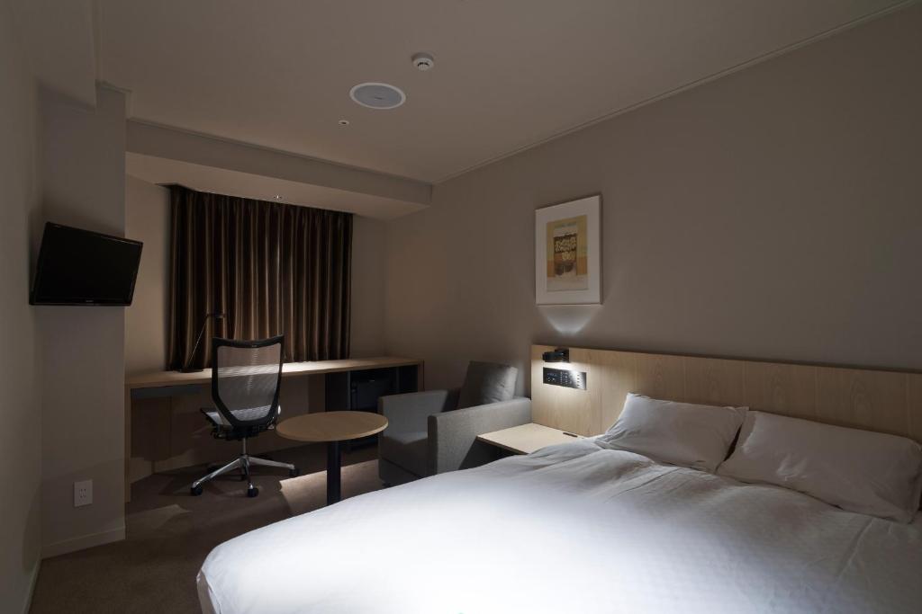 Postel nebo postele na pokoji v ubytování Rhino Hotel Kyoto