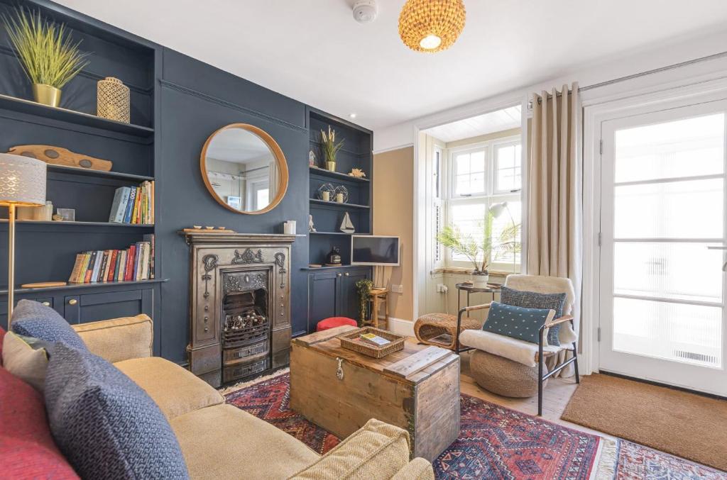 a living room with a fireplace and a mirror at Seagrass Cottage in Southwold, Stunning Property with Views! in Southwold