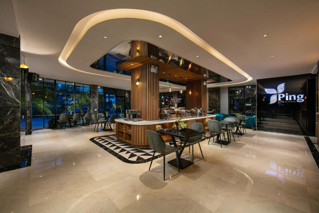 un restaurant avec des chaises et un bar dans un bâtiment dans l'établissement Ping Hotel, à Hanoï