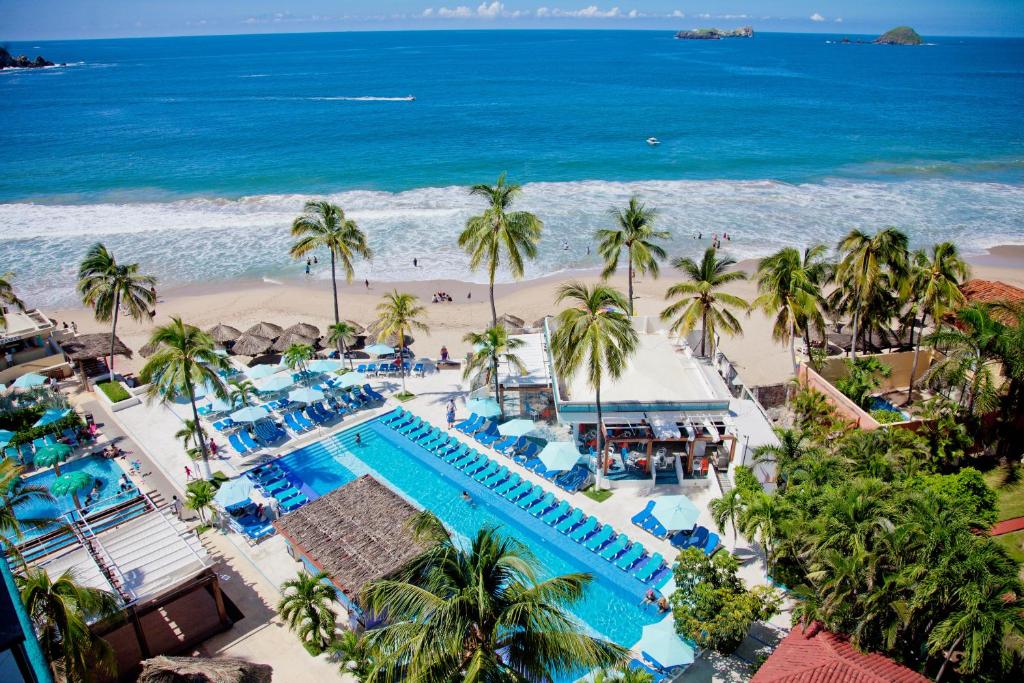 an aerial view of a resort with a pool and the beach at Fontan Ixtapa in Ixtapa