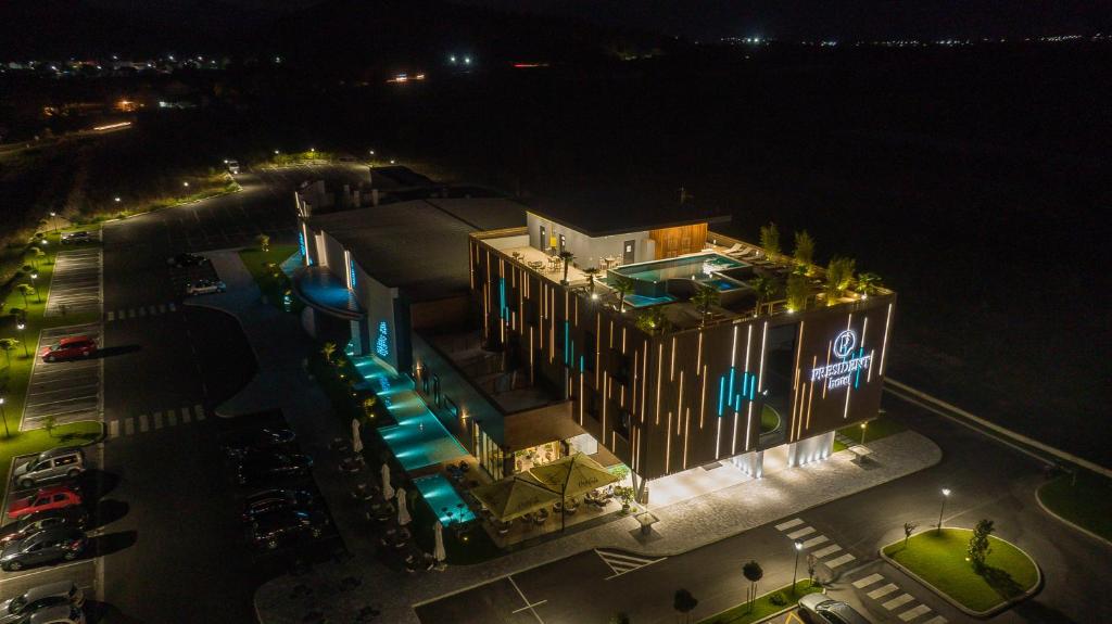 an overhead view of a building with a pool at night at Hotel President in Čapljina