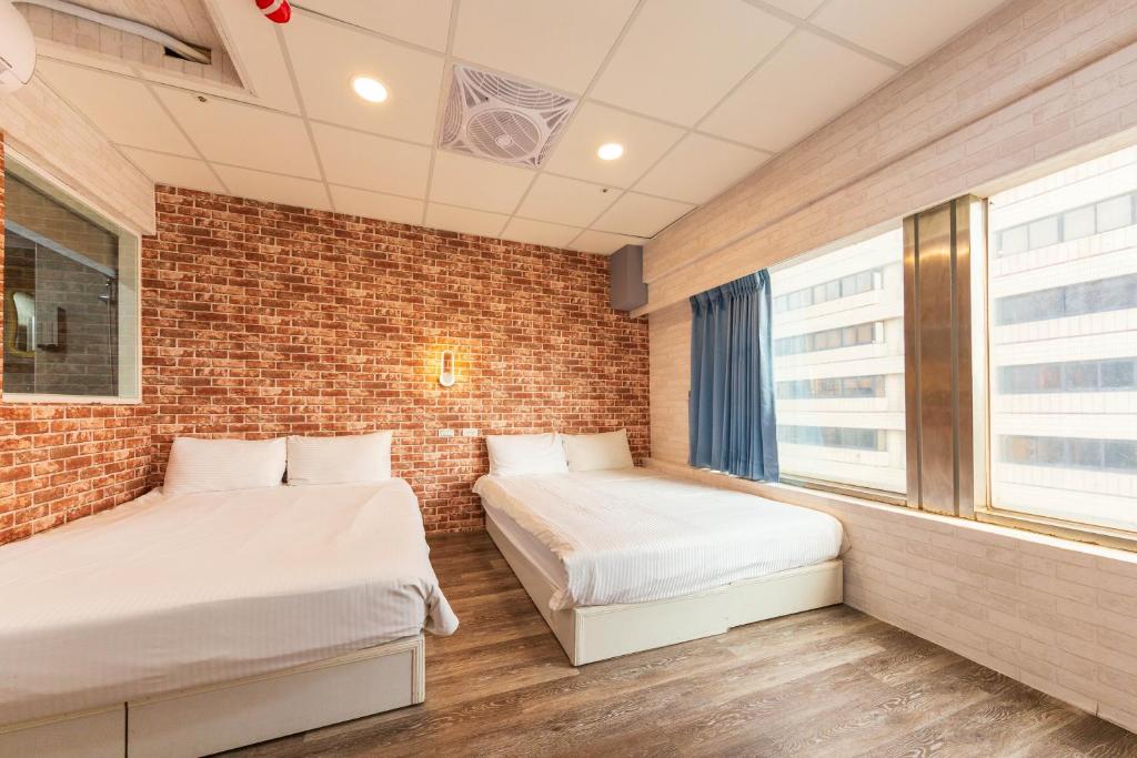 Postel nebo postele na pokoji v ubytování Liu He Su Hotel
