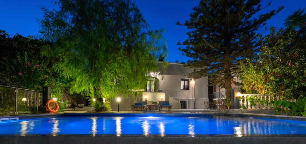 a swimming pool in front of a house at night at Villa Eleonora di Rodi in Rhodes Town