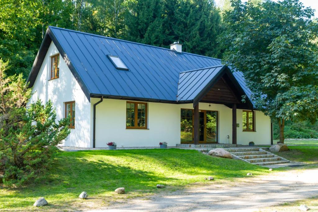 PurdaにあるBiały Domekの青屋根の小さな白い家