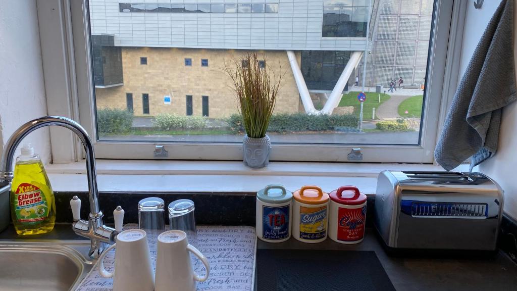 a kitchen counter with a sink and a window at bvapartments-Queensgate 2 in Huddersfield