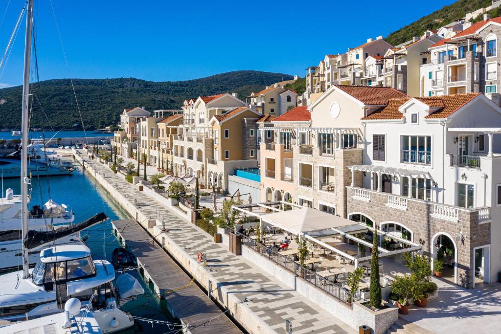 a view of a marina with boats and buildings at Lustica Bay in Tivat