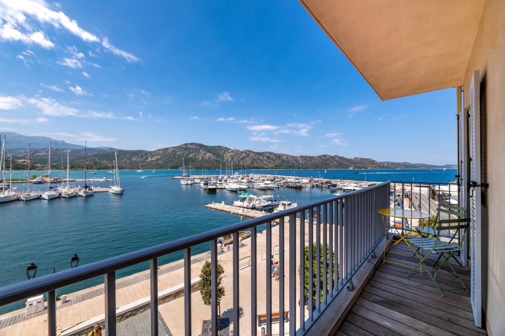 a balcony with a view of a marina at Casa Nostra : bienvenue chez nous ! in Saint-Florent