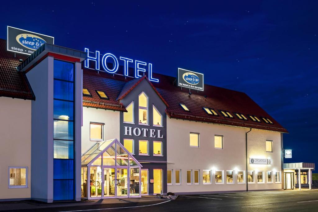 a hotel with a sign on the top of it at Hotel sleep & go in Bad Hersfeld