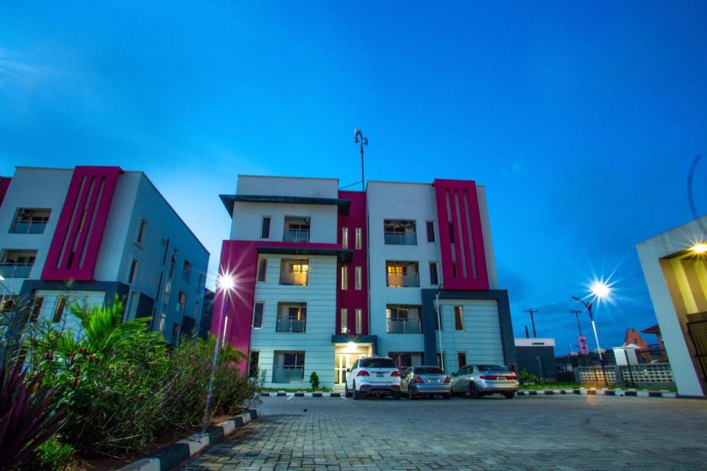 a building with cars parked in front of it at HOMEDALES Freedom Way LEKKI Phase1 LAGOS in Lekki