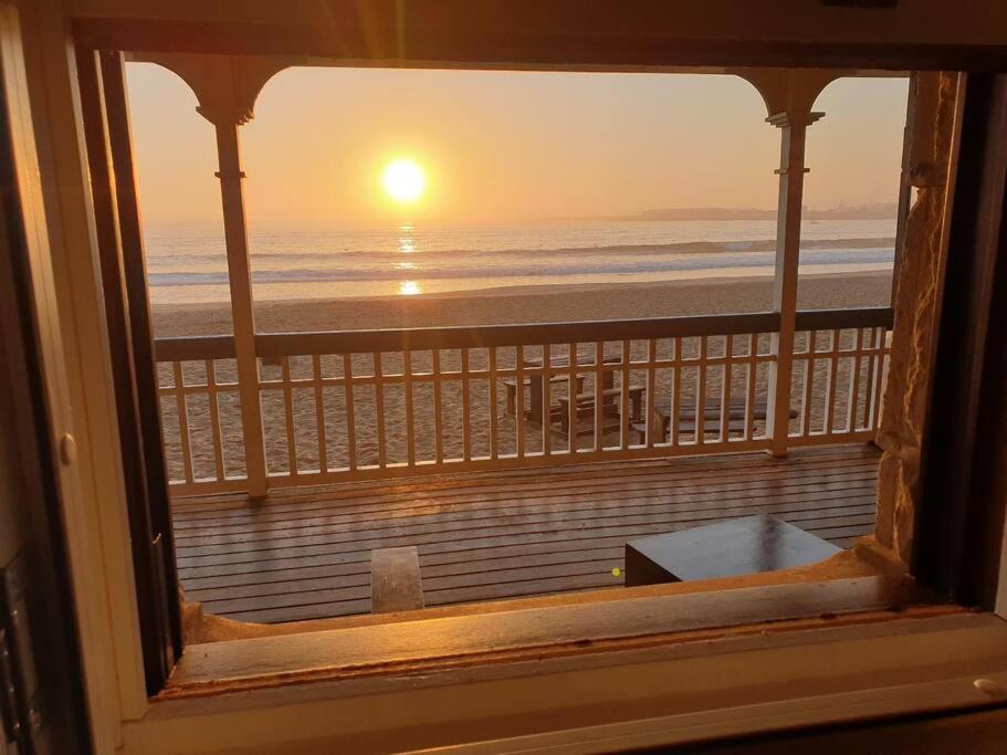 a view from a window of a beach sunset at Santos Beach Pavilion E in Mossel Bay