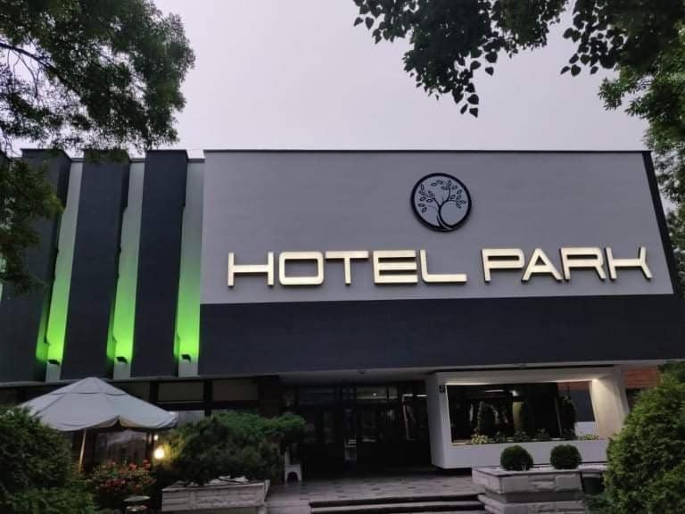 a hotel park with a clock on the front of it at Hotel Park in Opoczno