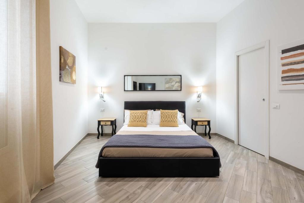 - une chambre avec un lit et un miroir mural dans l'établissement Navona 7 Suite, à Rome