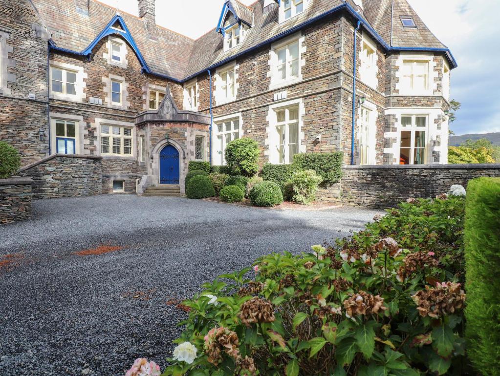 an old stone house with a blue door at Rydal Suite in Ambleside