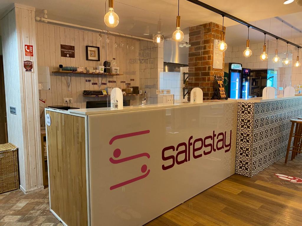 a restaurant with a saswegian sign on a counter at Safestay Bratislava Presidential Palace in Bratislava