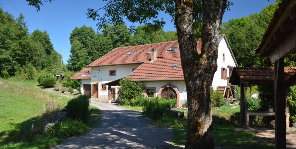 a white house with a red roof at Acconat-Domaine du Moulin ( 8 Gîtes ) in Ban-de-Sapt