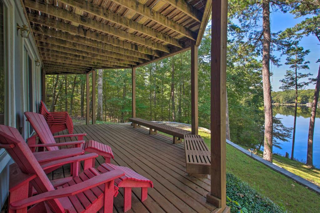 a deck with red chairs and a bench on a house at Dock and Kayaks Lakefront Hot Springs Home in Hot Springs