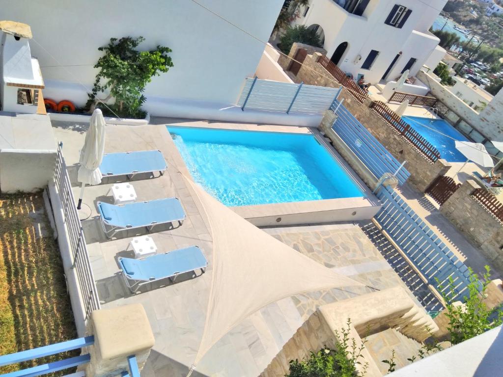 an overhead view of a swimming pool with lounge chairs and a swimming pool at Villa Danae - Seaside Villa with Pool & Hot Tub in Piso Livadi